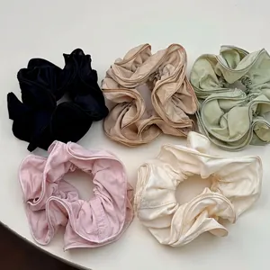 Five-pack set of ruffle edge scrunchies in pastel colors for elegant ponytails