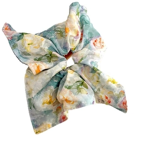Floral scrunchie with bow ribbon in light green and pastel prints for women's hair