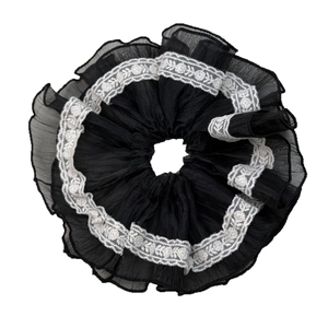 Elegant French style black scrunchie with white lace edges for hair styling