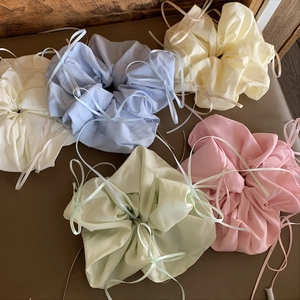 Set of five colorful silk-textured bow scrunchies in pastel colors for ballet style hair
