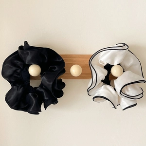 Elegant oversized satin scrunchies in solid black and white contrast design