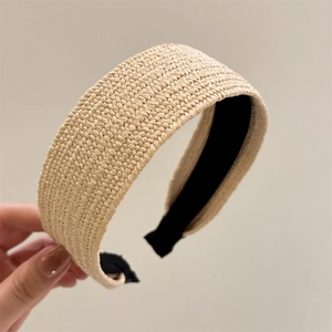 Close-up of wide-brimmed raffia woven headband with non-slip black inner fabric lining