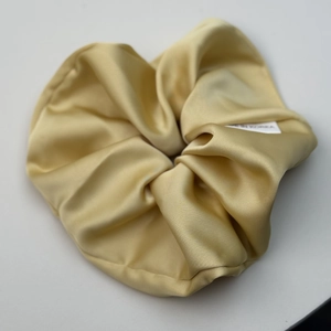 Détail du chouchou en satin doré champagne avec étiquette fabriqué en Corée