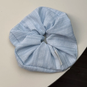 French blue plaid scrunchie with white eyelet lace details and a fabric tag