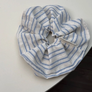 Detail showing the blue and white striped fabric texture and a handmade woven label
