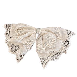 Elegant cream lace bow hair clip with pearl embellishments and embroidery details