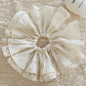 Detailed view of beige chiffon hair scrunchie with intricate floral lace embroidery