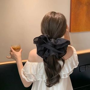 French style oversized black organza scrunchie with layered pleats on a low ponytail