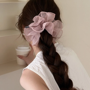 Pink double-layer mesh scrunchie shown on a braided hairstyle with soft pleats
