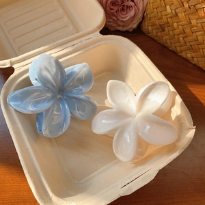 Blue and cream marble acetate plumeria flower hair claws in a decorative gift box