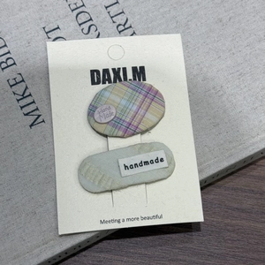 Lot de deux barrettes fait main avec carreaux violets et tissu bleu sur carte