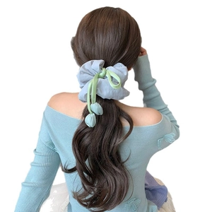 Light grey tulip scrunchie with green ribbons and blue floral charms for ponytail
