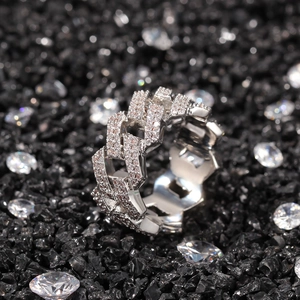 Détail d'une bague à maillons cubains en argent sertie de zircons sur gravier noir