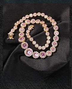 Macro view of gold-plated chain with circular pink zircon and white diamond clusters