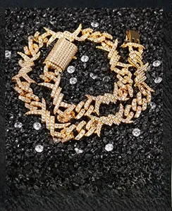 Macro shot of iced-out gold barbed wire cuban link necklace with rhinestones