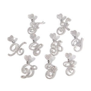 Macro shot of silver zircon-studded heart-shaped clasps and script letter pendants