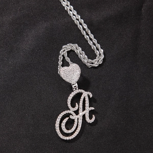 Detailed macro view of iced-out cursive letter A pendant with heart clasp and rope chain