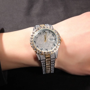Close-up of iced out gold watch with Hindi numbers and diamond-encrusted dial