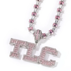 Macro shot of silver hip-hop TLC pendant with pink square-cut zircon stones