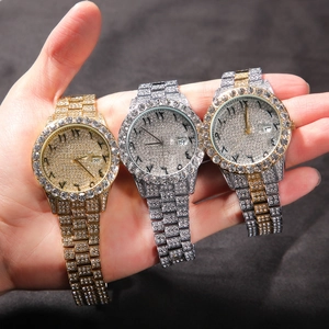 Close-up of iced-out quartz watches with Arabic numerals and date window in three colors
