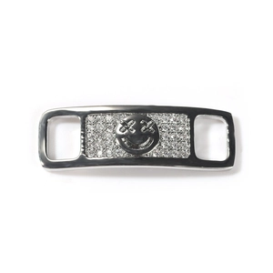 Polished silver shoe buckle featuring a pavé rhinestone smiley face with X-shaped eyes