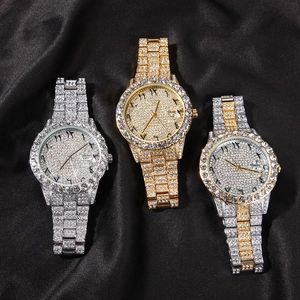 Detailed macro shot of luxury watches featuring iced-out diamonds and Arabic numeral dials