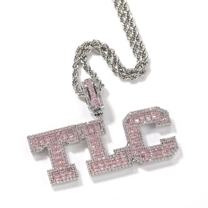 Detail of silver rope chain with large TLC letter pendant featuring pink zircon stones