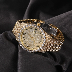 Detail of gold crystal watch with Arabic numerals and stainless steel buckle