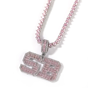 Macro shot of pink cubic zirconia stones on numeric 56 pendant and tennis chain detail