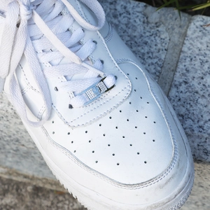 Hip hop silver smile shoe charm with sparkling zircon on white low top sneaker