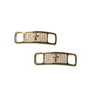 Pair of gold metal shoe charms with cross design and pave set cubic zirconia stones