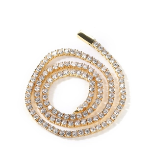 Detail of 4mm gold tennis chain featuring round cubic zirconia and a square box clasp
