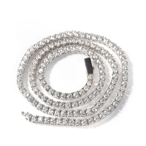Macro detail of 4mm silver tennis chain showing round cut diamonds in 4-prong setting