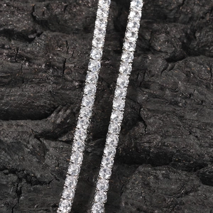 Macro shot of 4mm silver tennis chain featuring round cubic zirconia in four-prong setting