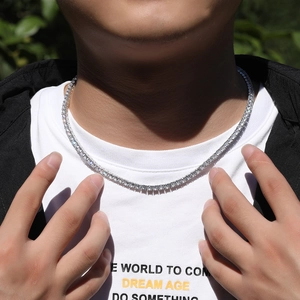 Detail of a 4mm silver tennis necklace with sparkling round-cut crystals on male model