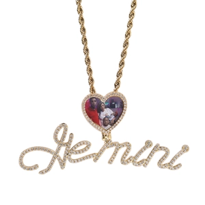 Detailed view of custom gold heart locket necklace with Gemini script and pavé zircons