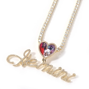 Close-up of gold heart locket and Kevin name pendant on a sparkling tennis chain