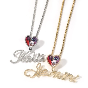 Detail of custom heart photo locket with zircon setting and script nameplate