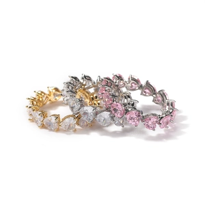 Detailed view of heart-shaped zircon row rings in gold, silver and pink tones