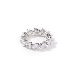 Macro shot of silver eternity ring with heart-shaped cubic zirconia in claw setting