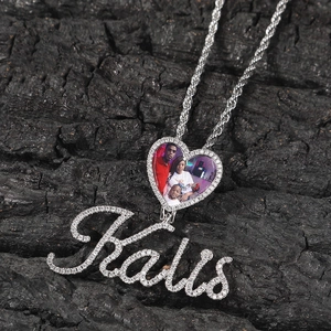 Close-up of heart locket pendant with micro-pave zircons and custom Kalis name script