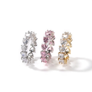 Macro detail of silver and gold eternity rings with heart-shaped cubic zirconia stones