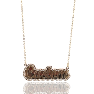 Macro view of custom gold letter necklace with sparkling crystals and double layer detail