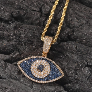 Vue macro du pendentif Hip Hop œil maléfique avec zircons bleus et chaîne dorée