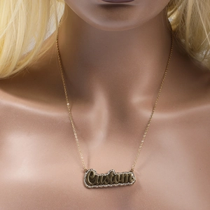 Detail of custom double-layered gold name necklace with sparkling micro-inlaid borders