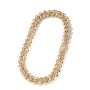 Close-up of 15mm gold Cuban link necklace with baguette-cut CZ stones and box clasp