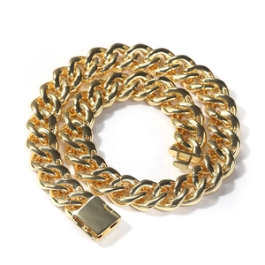 Detail of 15mm gold-plated Cuban link chain showing the heavy polished metal and clasp