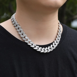 Detail of silver Cuban chain necklace with sparkling zircons worn by a male model