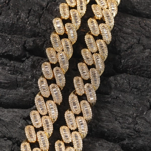 Macro detail of iced out gold Cuban link chain with baguette cut white zircons