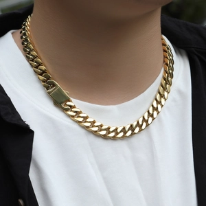 Close-up of a thick gold 12mm Cuban link chain with a secure rectangular box clasp